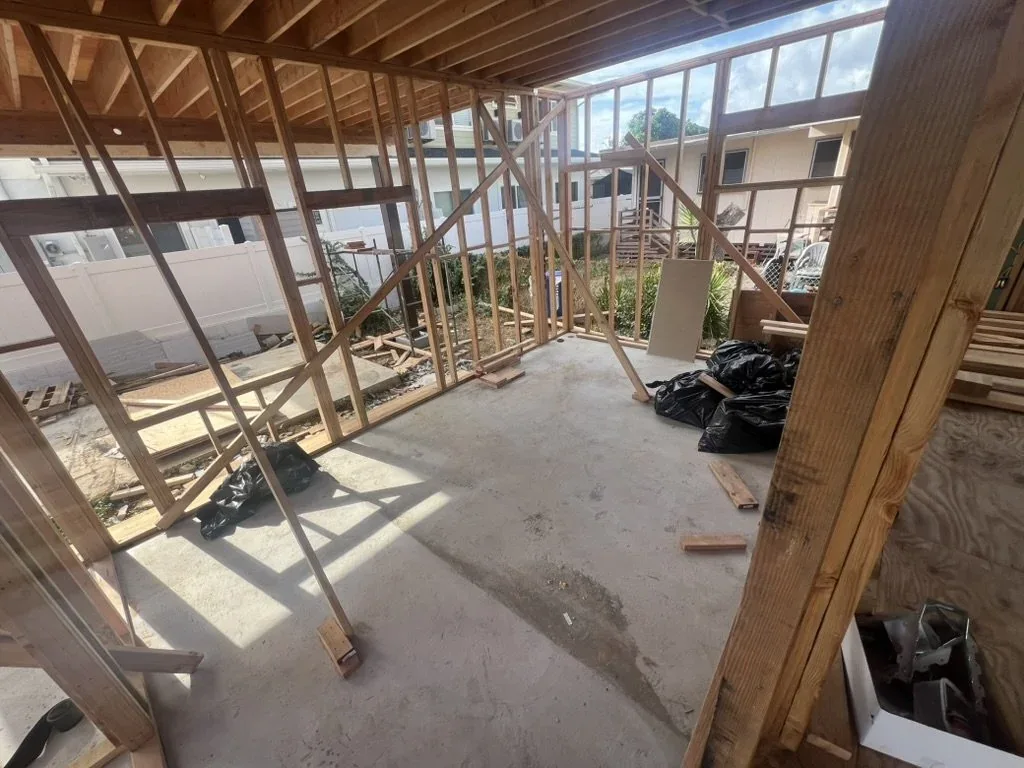 Framed bedroom with large window and private entrance to the side yard.